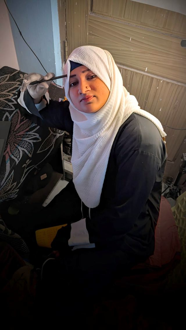 Fathima Samreen writing at her desk